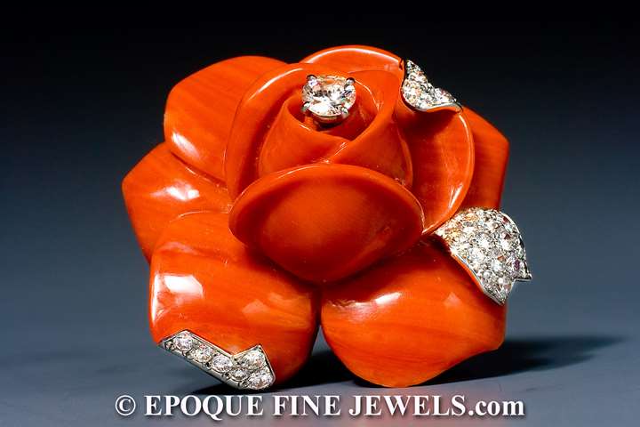 A striking coral and diamond flower brooch